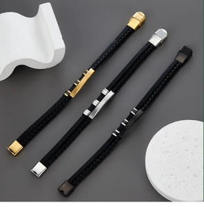 Close-up of multilayer braided leather bracelets with gold, silver, and black steel plates