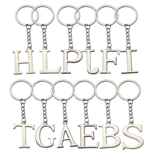 Professional white background shot of polished silver metal alphabet keychains in various letters
