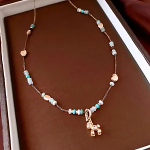 Beaded golden necklace with a zircon puppy pendant and vintage Maillard style stones