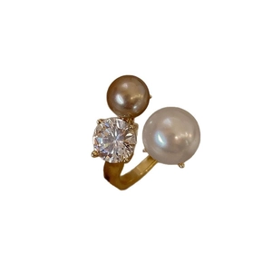 Irregular gold open ring with large white pearl, champagne pearl, and zircon stone accent