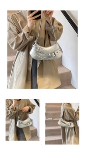 Detail of silver baguette bag featuring punk buckles and metallic faux leather finish