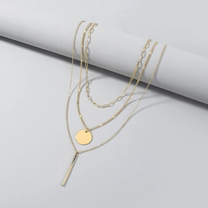 Three-layer gold necklace featuring a round disc and vertical bar pendants for women