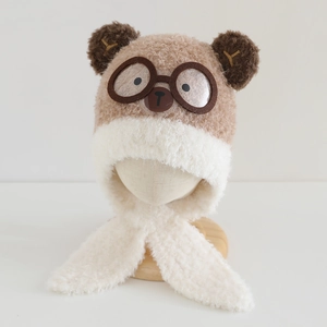 Detail of plush bear-shaped kids hood with 3D ears and goggles design for winter warmth
