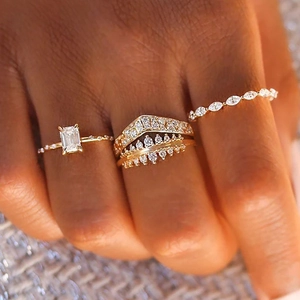 Detail of stacked s925 silver wedding rings featuring emerald cut and marquise diamonds