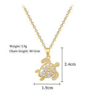 Detailed view of hollow turtle pendant with sparkling crystals and size specifications