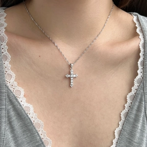 Close-up of S925 sterling silver cross pendant necklace with zircon and opal on model