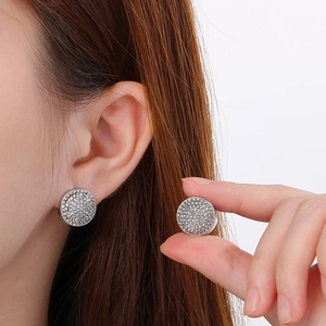 Close-up of sparkling pavé crystal hoop earrings in silver-tone polished finish