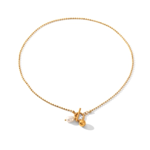 Detailed close-up of gold beaded necklace featuring OT toggle clasp and pearl pendant
