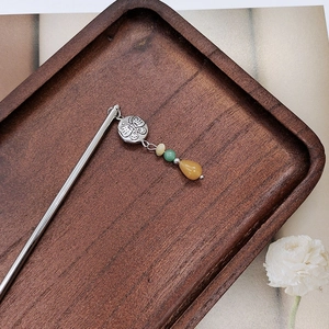 Detail of silver Miao-style hair stick with butterfly ornament and colorful beads
