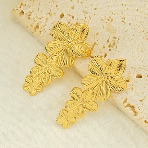 Exaggerated vintage gold-plated titanium steel triple flower earrings on stone texture