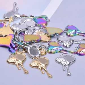 Polished heart-shaped Dream pendants in gold, silver and rainbow stainless steel