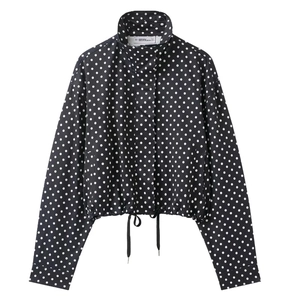 Detailed view of polka dot jacket with stand collar and drawstring hem design