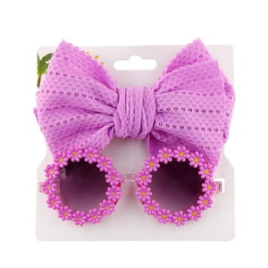 Detailed view of purple daisy flower sunglasses and matching mesh bow headband set