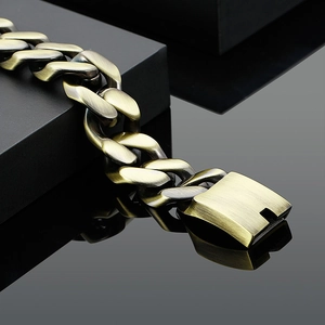 Macro detail of vintage bronze cuban link bracelet with heavy brushed metal texture