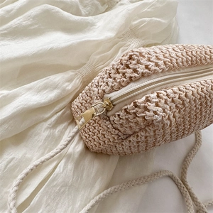 Handmade woven mini crossbody bag for summer featuring a beige straw texture and zipper