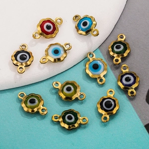 Detail of 11 colorful enamel evil eye connectors with 18K gold-plated frames for DIY jewelry