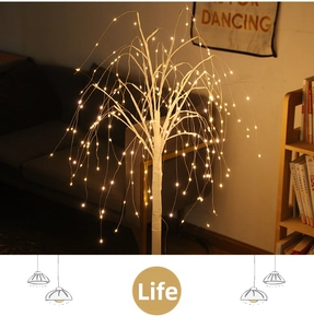 Detail view of warm LED weeping willow tree lamp with white trunk for home holiday decor