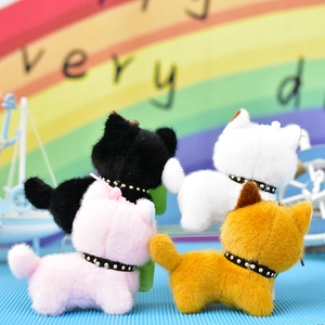 Detailed view of colorful plush kitten charms with studded collars in a playful setting