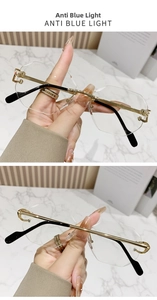 Macro detail of rimless anti-blue light glasses with geometric lenses and golden metal temples