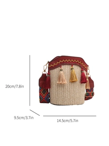 Detail view of woven straw bucket bag with red PU trim and ethnic wide strap dimensions