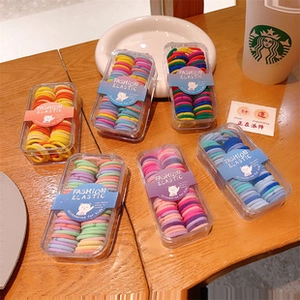 Set of colorful elastic hair bands for kids in six transparent storage boxes