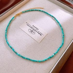 Detailed view of turquoise beaded square stone necklace with adjustable golden lobster clasp
