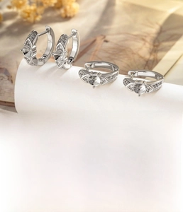 Macro detail of silver-plated hoop earrings with micro-set zircon and geometric patterns