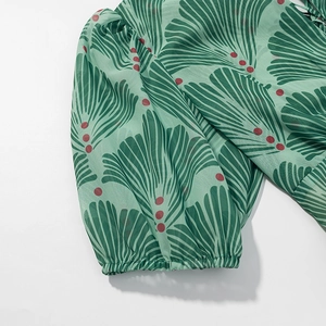 Detail of green floral chiffon dress sleeve with elastic cuffs and ginkgo leaf print