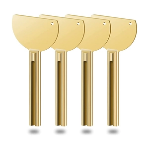 Macro detail of four gold-plated metal toothpaste squeezers with non-slip texture