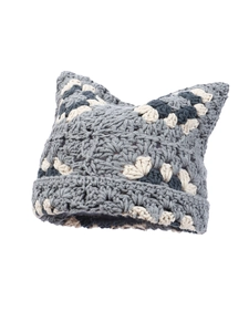 Detail of handmade crochet knit hat featuring gray and white cat ear design and texture