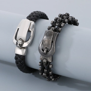 Detail view of woven leather bracelets with silver lion head and punk skull buckle charms