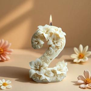 Floral relief number 2 candle with burning flame and decorative petals on warm background