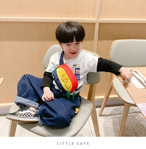 Detailed view of kids cute bus-shaped crossbody bag with vibrant multi-color patchwork design