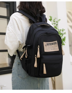 Black durable nylon backpack with large capacity and multi-pocket design for students