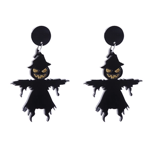 Detail of Halloween black scarecrow acrylic earrings with golden eye accents on white backdrop