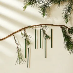 Christmas tree scented sticks in dark green hanging on a natural pine branch
