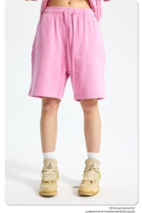 Detail of pink cotton knit shorts showing elastic drawstring waistband and fabric texture