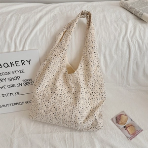 Detailed close-up of the floral canvas tote bag showing fine fabric texture and pattern
