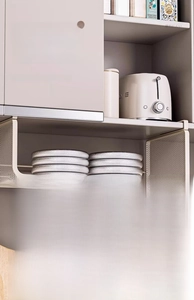 Detail of sturdy white metal under-cabinet wire basket showing high load capacity and hooks