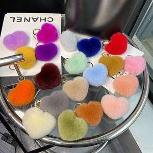 Top view of colorful heart-shaped rex rabbit fur keychains in various vibrant shades