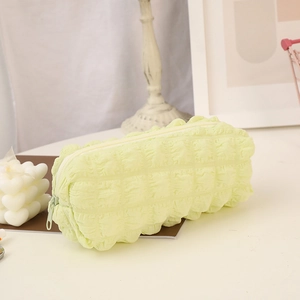 Detail of light green puff textured stationery bag with soft fabric and zipper