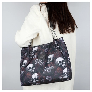 Detail of floral skull pattern nylon shoulder bag worn by model showing actual size