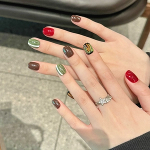 Handmade press-on nails in deep red and olive green with vintage hand-painted patterns