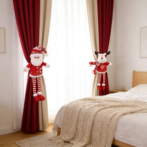 Close-up of knitted Santa and Reindeer curtain tiebacks on white bedroom curtains