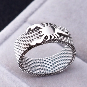 Detail of 8mm silver steel ring showing the woven mesh band and vivid scorpion pattern