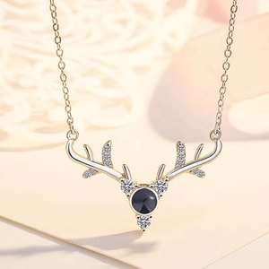 Detail of deer antler necklace featuring a black projection stone and zircon accents