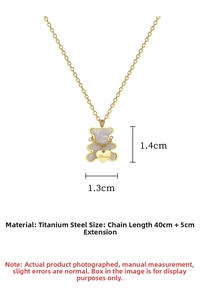 Macro detail of bear pendant in gold titanium steel with dimensions and Love charm