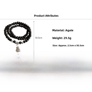 Detail view of multilayer black agate beaded bracelet with silver money bag charm and specs