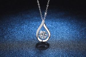 Macro shot of 1 carat moissanite teardrop pendant necklace with brilliant silver finish