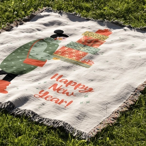 Close-up of bohemian Christmas tree throw blanket with fringes on green grass outdoor